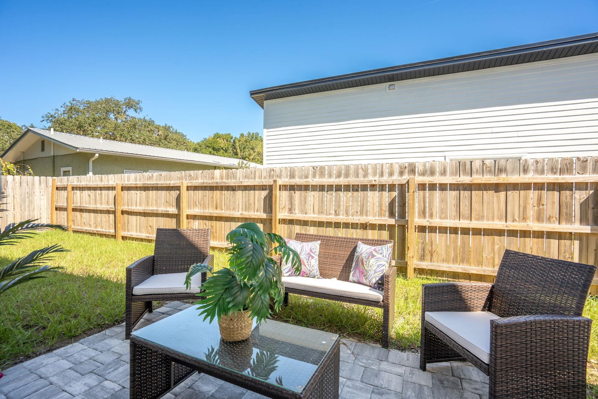 812 West 9th Street St. Augustine, FL 32084 - Photo 23 of 31 Fenced backyard with a patio area