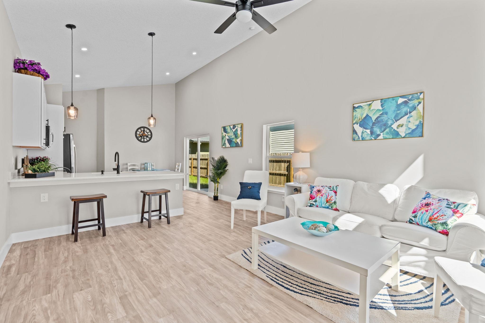 812 West 9th Street St. Augustine, FL 32084 - Photo 3 of 31 Living area with high vaulted ceiling, light wood finished floors, recessed lighting, and a ceiling fan