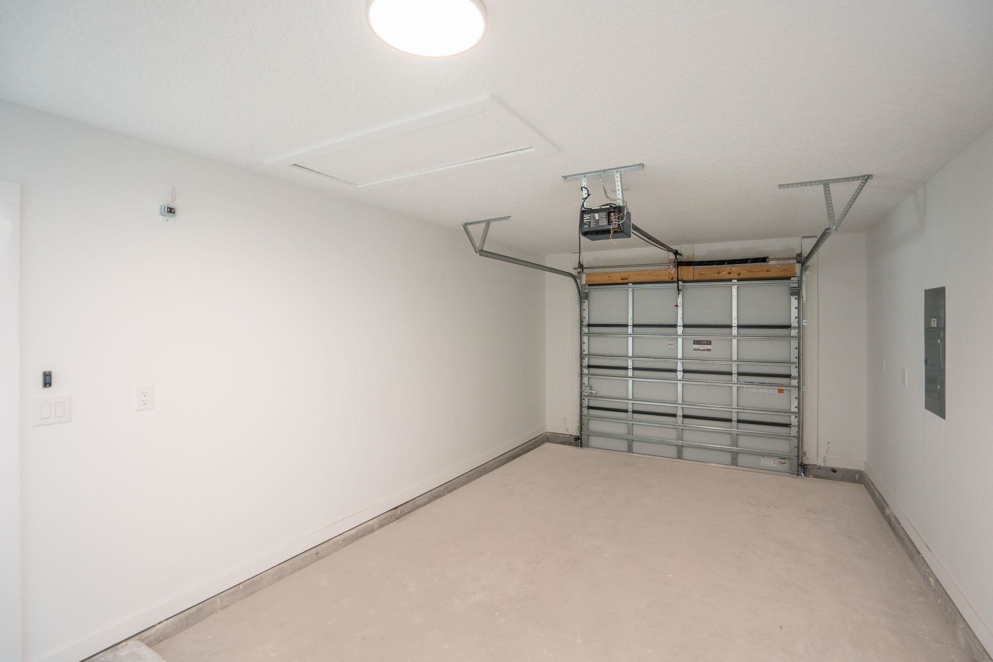 812 West 9th Street St. Augustine, FL 32084 - Photo 29 of 31 Garage featuring electric panel and a garage door opener