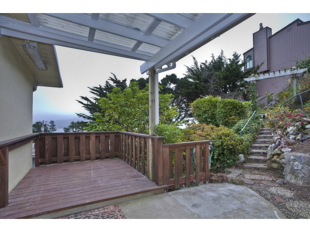 128 Kent Road Pacifica, CA 94044 - Photo 1 of 24 a balcony with wooden floor