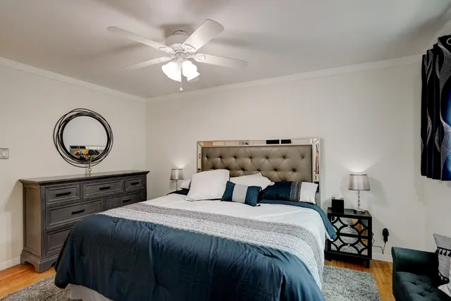 a bedroom with a bed tv and a window