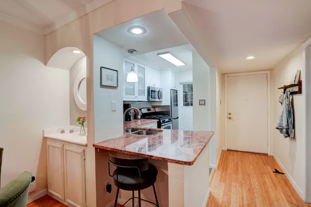 a view of a kitchen and an entryway