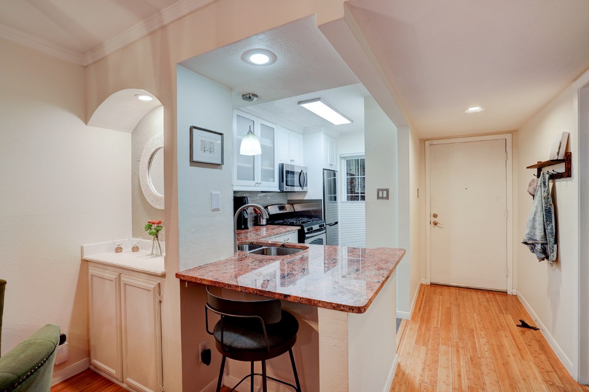 7920 Rockwood Lane, Unit 128 Austin, TX 78757 - Photo 2 of 36 a kitchen with stainless steel appliances kitchen island a refrigerator sink and cabinets