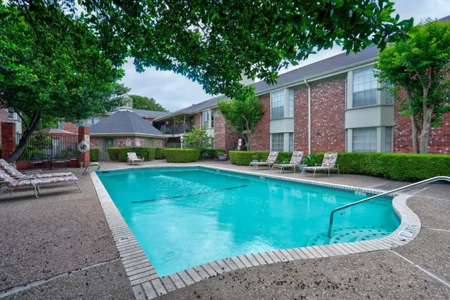 a front view of a house with a yard and potted plants