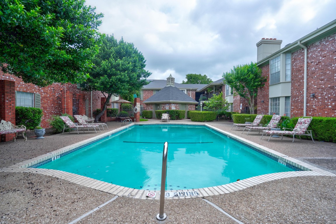 7920 Rockwood Lane, Unit 128 Austin, TX 78757 - Photo 30 of 36 a view of a swimming pool with a patio