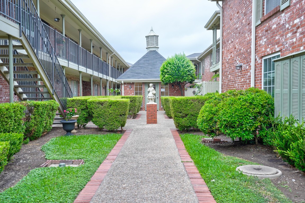 7920 Rockwood Lane, Unit 128 Austin, TX 78757 - Photo 34 of 36 a front view of a house with a yard and potted plants