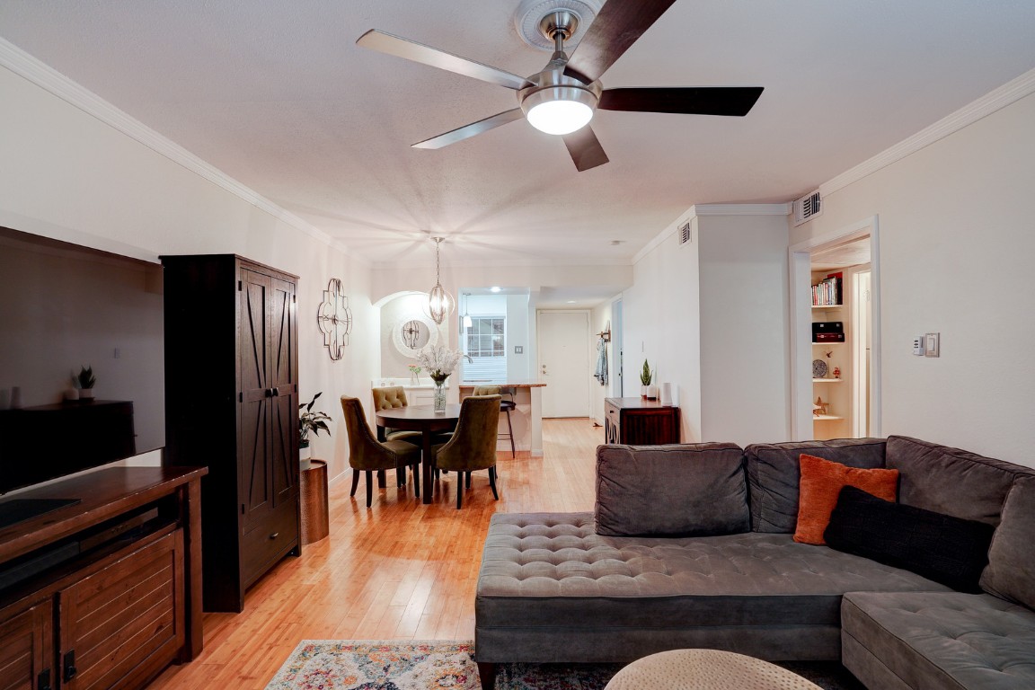 7920 Rockwood Lane, Unit 128 Austin, TX 78757 - Photo 8 of 36 a living room with furniture wooden floor and a chandelier