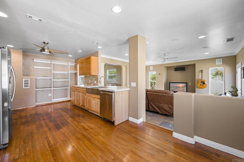 2548 Mesa Drive Oceanside, CA 92054 - Photo 12 of 33 a large kitchen with a center island wooden floor and stainless steel appliances