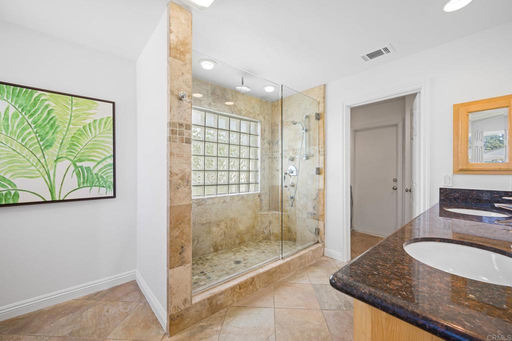 2548 Mesa Drive Oceanside, CA 92054 - Photo 21 of 33 a bathroom with a granite countertop sink a mirror and shower