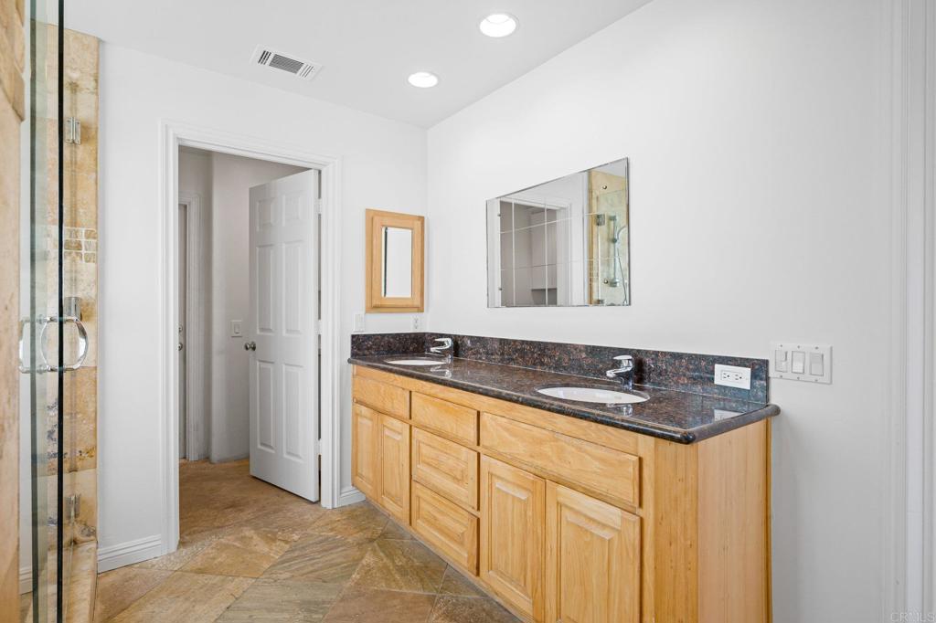 2548 Mesa Drive Oceanside, CA 92054 - Photo 22 of 33 a bathroom with a granite countertop sink and a mirror