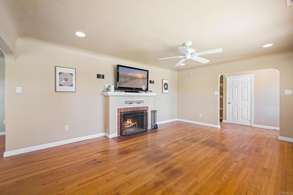2548 Mesa Drive Oceanside, CA 92054 - Photo 4 of 33 a view of empty room with a fireplace and wooden floor