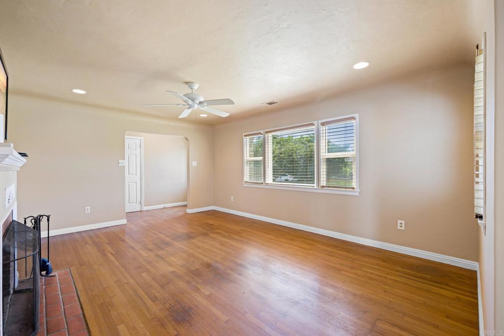 2548 Mesa Drive Oceanside, CA 92054 - Photo 5 of 33 a view of an empty room with wooden floor and a window