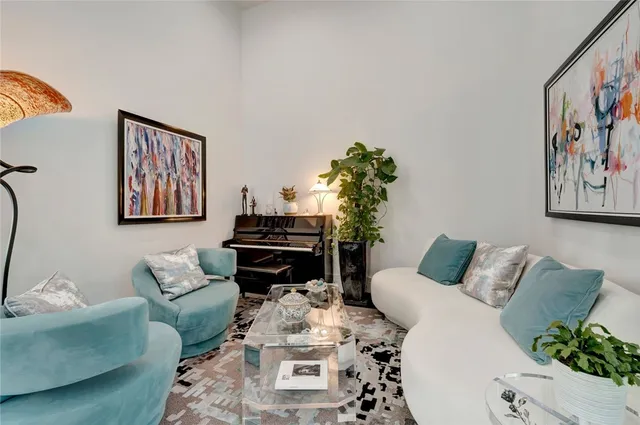 a living room with furniture and a potted plant