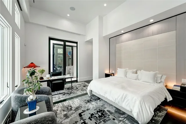 a bedroom with a bed and a potted plant