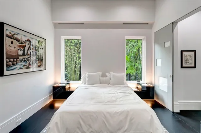 a bedroom with a large bed and a window