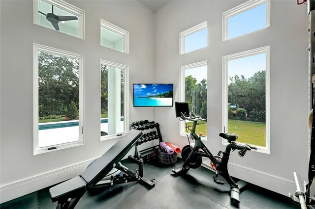 a room with gym equipment and a large window