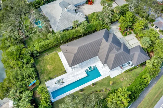 an aerial view of a house with a lake view