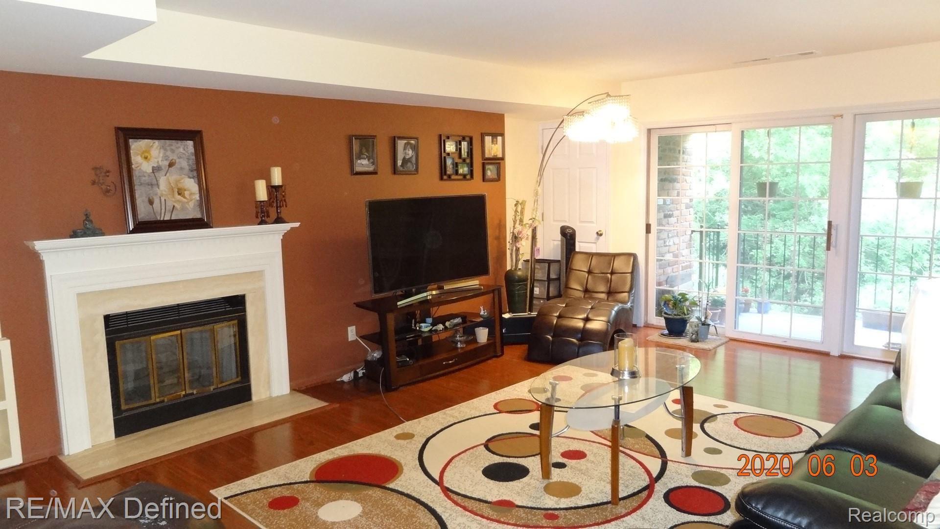 1675 Huntington Park, Unit E Rochester, MI 48309 - Photo 8 of 33 Gas fireplace with built-in bookcase