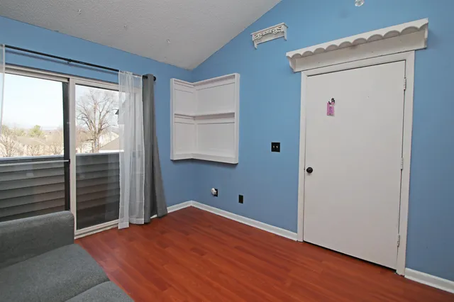 a view of a room with wooden floor and windows