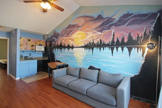 a living room with furniture and a large window