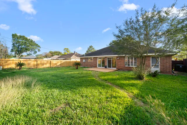 a view of a house with a yard and sitting area