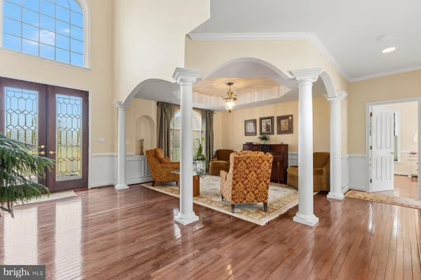 a living room with furniture and a table with wooden floor
