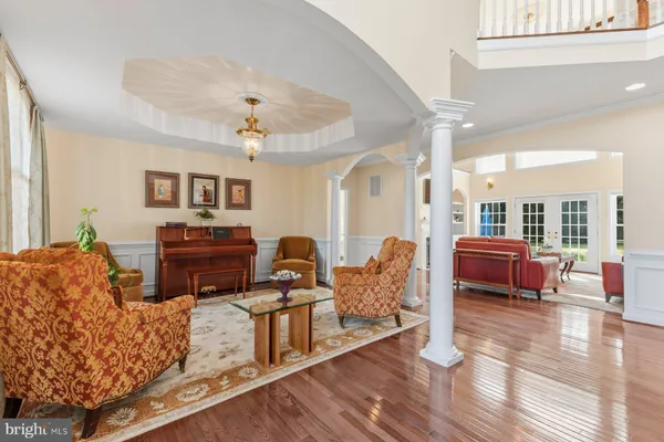 a living room with furniture ceiling fan and a large window