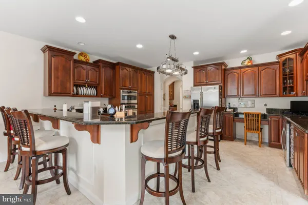 a kitchen with stainless steel appliances granite countertop a sink and stove top oven