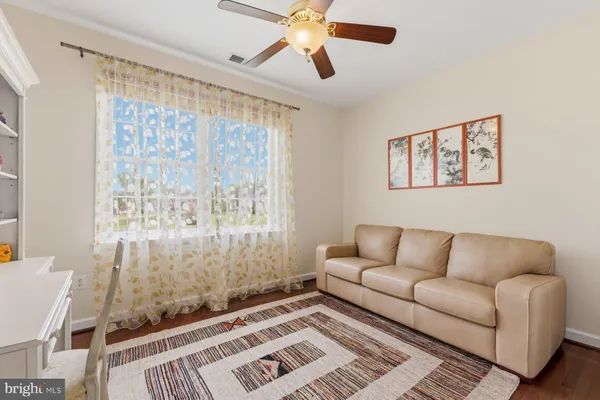 a room with a bookshelf and a window