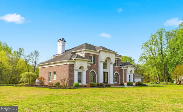 a big house with swimming pool in front of it