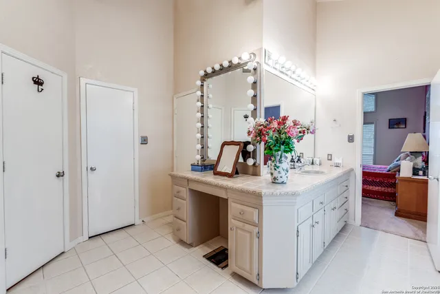 a bathroom with a sink vanity and a mirror