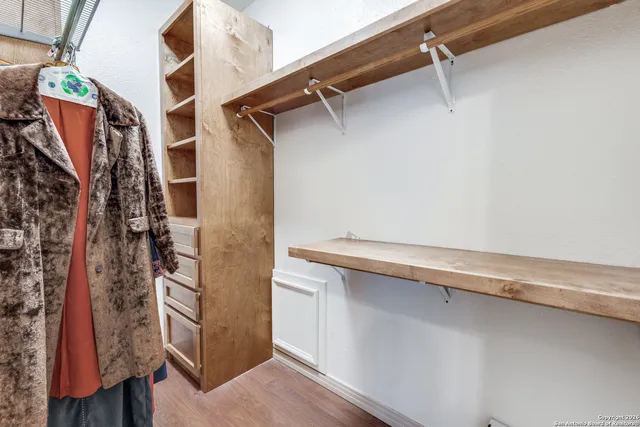 a bedroom with furniture and a window