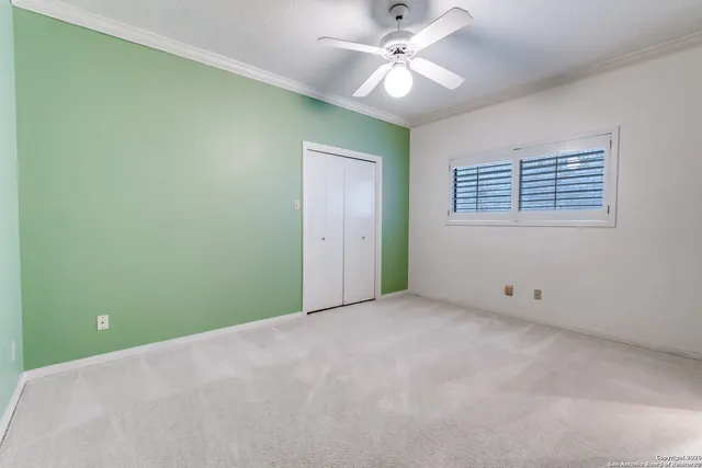 a kitchen with a stove and white cabinets
