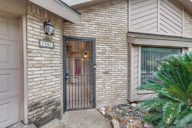 a view of a door and brick walls