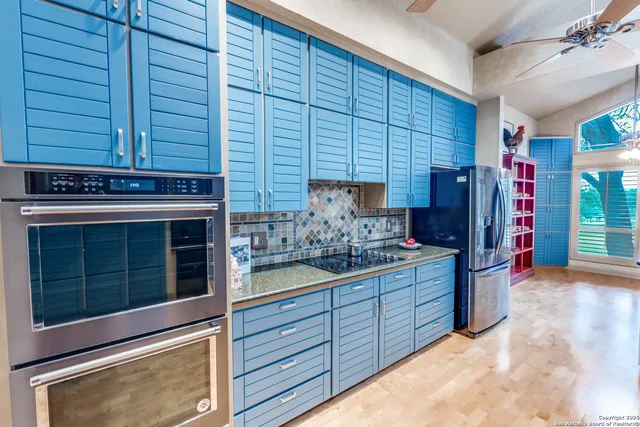 a kitchen with stainless steel appliances granite countertop a sink and a counter