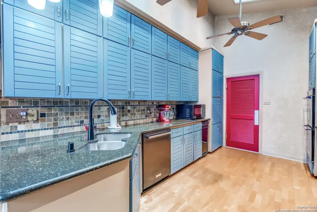 a kitchen with stainless steel appliances granite countertop a refrigerator and a sink