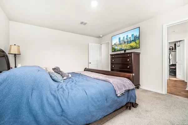 a bedroom with a bed and a dresser