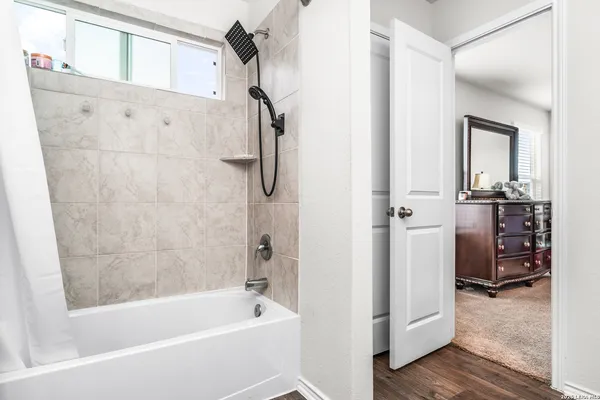 a bathroom with a bathtub and a shower