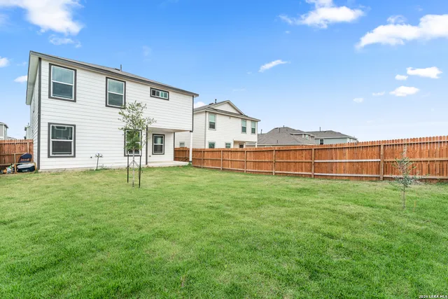 a view of a house with a backyard