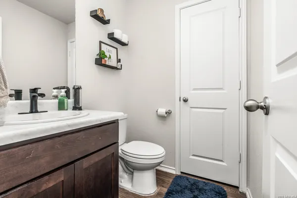 a bathroom with a toilet a sink and mirror