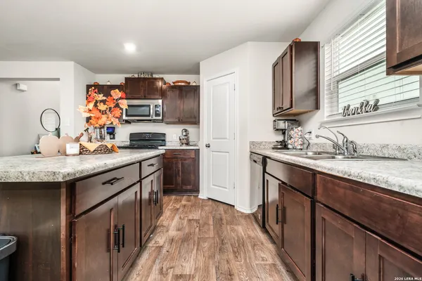 a kitchen with granite countertop a sink and cabinets