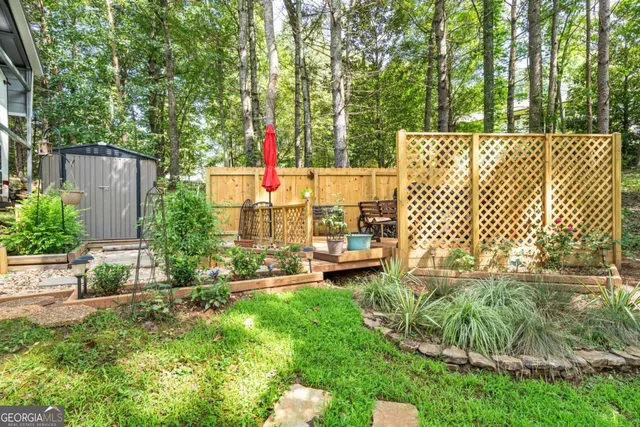 a view of a backyard with table and chairs