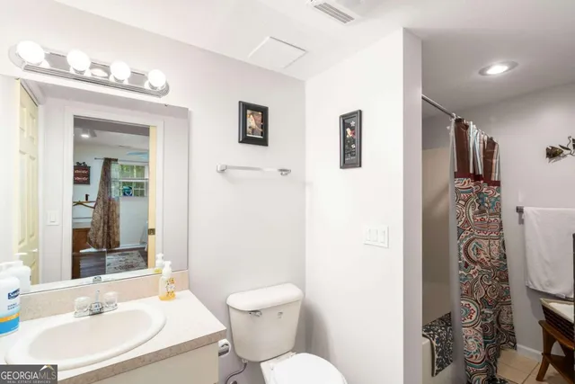 a view of back yard and deck with table and chairs