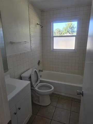 a bathroom with a toilet a sink and bathtub