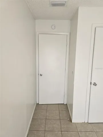 an empty room with a wooden door