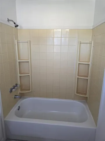 a view of a room with wooden floor and a window