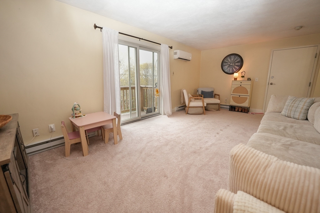 90-92 Sandwich Road, Unit 9C Bourne, MA 02532 - Photo 4 of 10 a living room with furniture and a window