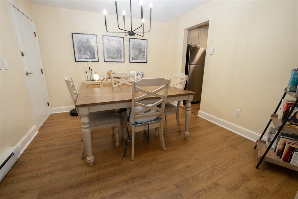 90-92 Sandwich Road, Unit 9C Bourne, MA 02532 - Photo 5 of 10 a dining room with furniture and wooden floor
