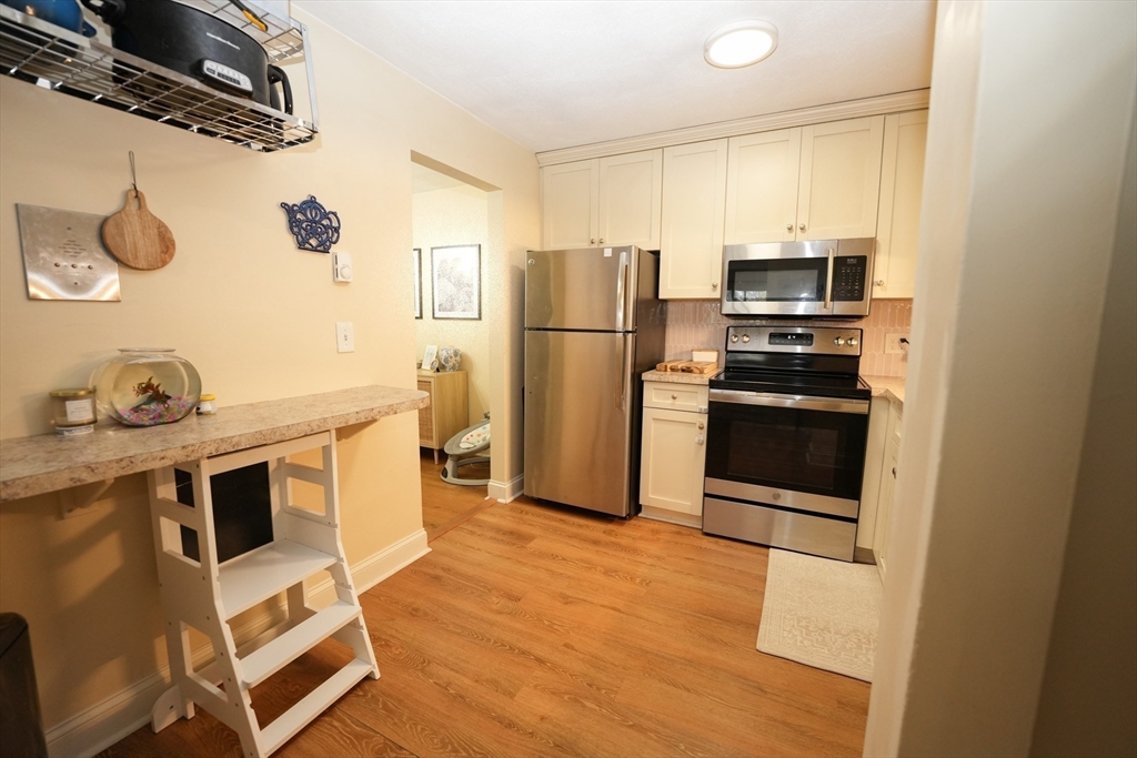 90-92 Sandwich Road, Unit 9C Bourne, MA 02532 - Photo 6 of 10 a kitchen with stainless steel appliances a stove a refrigerator and a sink