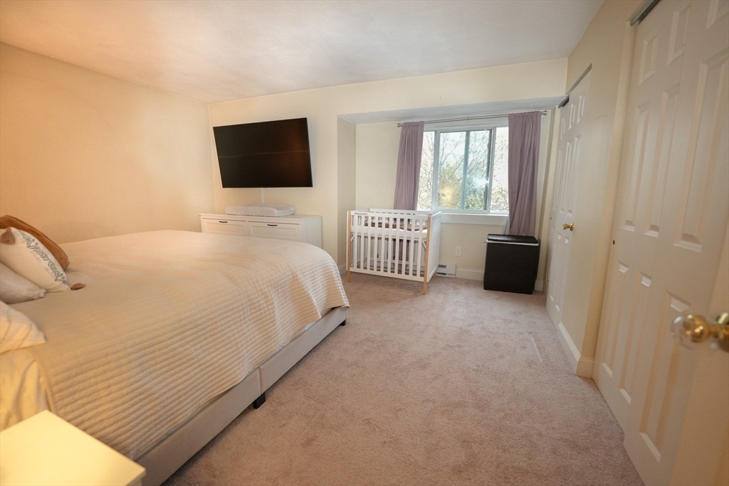 90-92 Sandwich Road, Unit 9C Bourne, MA 02532 - Photo 7 of 10 a bedroom with a bed and flat screen tv
